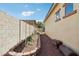 Featuring a gravel side yard for outdoor storage, gardening area, and utility access with added privacy at 15849 W Alvarado Dr, Goodyear, AZ 85395