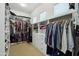 Well-organized walk-in closet with ample storage space, built-in shelving and racks for clothes and accessories at 15849 W Alvarado Dr, Goodyear, AZ 85395