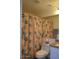 Cozy bathroom featuring a floral shower curtain and vanity area at 1701 E Colter St # 280, Phoenix, AZ 85016