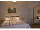 Bright bedroom with unique bedspread, bedside lamps, and a mirrored closet showcasing the space at 1701 E Colter St # 280, Phoenix, AZ 85016