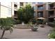 Beautiful courtyard with fountain, lush landscaping, and seating areas for relaxing in the community at 1701 E Colter St # 280, Phoenix, AZ 85016