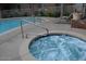 Close-up of the hot tub with seating for relaxing and the pool nearby at 1701 E Colter St # 280, Phoenix, AZ 85016