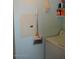 A laundry room with white washing machine, light blue walls, and cleaning supplies at 1701 E Colter St # 280, Phoenix, AZ 85016