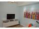 Modern living room with a wall mounted TV and a white entertainment center at 1701 E Colter St # 280, Phoenix, AZ 85016