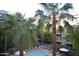 Elevated view of the pool and palm trees with plenty of seating for relaxing in the sun at 1701 E Colter St # 280, Phoenix, AZ 85016
