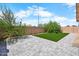 Landscaped backyard featuring a stone patio, grass and mature trees at 17912 N 88Th Dr, Peoria, AZ 85382
