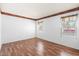 Bright bedroom with wood-look flooring, neutral walls, and dual windows overlooking the yard at 17912 N 88Th Dr, Peoria, AZ 85382