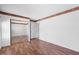 Spacious bedroom featuring wood-look floors, a sliding closet door and a door to another room at 17912 N 88Th Dr, Peoria, AZ 85382