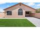 Single-story home exterior showcasing new, low-maintenance turf and stone walkways at 17912 N 88Th Dr, Peoria, AZ 85382