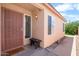Inviting front porch with security screen door and welcome mat. Bench seating at 17912 N 88Th Dr, Peoria, AZ 85382