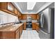 Well-equipped kitchen with stainless steel appliances, wood cabinets, and tile backsplash at 17912 N 88Th Dr, Peoria, AZ 85382