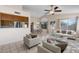 Open-concept living room and dining area with neutral decor and tile floors at 17912 N 88Th Dr, Peoria, AZ 85382