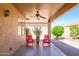 Relaxing back patio with ceiling fan and comfortable seating; ideal for enjoying the outdoors at 17958 W Udall Dr, Surprise, AZ 85374