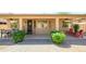 Exterior view of covered patio with outdoor dining and lounge areas, framed by lush greenery at 17958 W Udall Dr, Surprise, AZ 85374