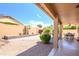 A charming backyard boasts a covered patio, desert landscaping, and a quaint seating area at 17958 W Udall Dr, Surprise, AZ 85374