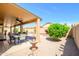 Relaxing backyard patio with a water fountain, dining area, and easy-care desert landscaping at 17958 W Udall Dr, Surprise, AZ 85374