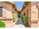 Inviting front entryway with mature green landscaping leading to the front door at 17958 W Udall Dr, Surprise, AZ 85374