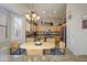 Bright kitchen with tan cabinets, stainless appliances, granite counters, and a charming breakfast nook at 17958 W Udall Dr, Surprise, AZ 85374