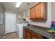 Functional laundry room with washer, dryer, cabinets, and counter space at 17958 W Udall Dr, Surprise, AZ 85374