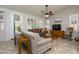 Bright living room featuring ample natural light, tile floors, and a comfortable seating arrangement at 17958 W Udall Dr, Surprise, AZ 85374