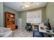 Office space featuring a desk, shelving, and a comfortable seating area at 17958 W Udall Dr, Surprise, AZ 85374