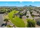 Aerial view of the community highlighting a green space, residential houses, and mountain views at 1887 W Desert Seasons Dr, Queen Creek, AZ 85144