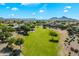 Scenic aerial view of the community showcasing vast green space, neighborhood, and distant mountains at 1887 W Desert Seasons Dr, Queen Creek, AZ 85144