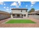 Backyard with pavers, gravel, and artificial grass; features the two-story house and covered patio at 1887 W Desert Seasons Dr, Queen Creek, AZ 85144