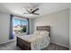 Cozy bedroom with floral bedding, dark furniture, carpet, and natural light from the window at 1887 W Desert Seasons Dr, Queen Creek, AZ 85144