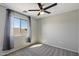 Empty bedroom with carpet, neutral walls, modern fan and natural light from large window at 1887 W Desert Seasons Dr, Queen Creek, AZ 85144