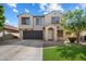 Charming two-story home with a well-manicured lawn and a two-car garage, complete with desert landscaping at 1887 W Desert Seasons Dr, Queen Creek, AZ 85144