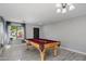 Bright game room featuring a wooden pool table with red felt, complemented by gray tile floors and neutral walls at 1887 W Desert Seasons Dr, Queen Creek, AZ 85144