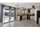 Open kitchen with stainless steel appliances, tile floors, views of backyard and light wood cabinets at 1887 W Desert Seasons Dr, Queen Creek, AZ 85144