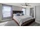 Inviting main bedroom with plush bed, soft carpet, and two light-filled windows at 1887 W Desert Seasons Dr, Queen Creek, AZ 85144