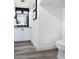 Modern half-bathroom with tiled floors, black-framed mirror, and elegant wall decor at 1961 N Hartford St # 1162, Chandler, AZ 85225