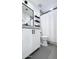 Bathroom with white vanity, black accents, and floating shelves, offering clean and modern aesthetic at 1961 N Hartford St # 1162, Chandler, AZ 85225
