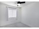 Bright bedroom featuring a ceiling fan, window with blinds, and neutral-toned carpet at 1961 N Hartford St # 1162, Chandler, AZ 85225