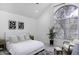 Serene bedroom featuring a large arched window, neutral tones, and contemporary decor at 1961 N Hartford St # 1162, Chandler, AZ 85225