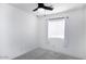 Bright bedroom featuring a ceiling fan, window with blinds, and neutral-toned carpet at 1961 N Hartford St # 1162, Chandler, AZ 85225