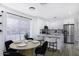 Bright open-concept kitchen and dining area featuring a marble island with seating and stainless steel appliances at 1961 N Hartford St # 1162, Chandler, AZ 85225
