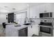 Contemporary kitchen featuring a large island, stainless steel appliances, and white cabinetry at 1961 N Hartford St # 1162, Chandler, AZ 85225