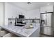 Modern kitchen with sleek, white cabinets, stainless steel appliances, and a spacious marble countertop island at 1961 N Hartford St # 1162, Chandler, AZ 85225