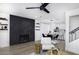 Spacious living area featuring a modern fireplace, dining area, and open floor plan with hardwood floors at 1961 N Hartford St # 1162, Chandler, AZ 85225
