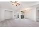 Bright living room featuring neutral carpet, ceiling fan, and natural light from large windows at 200 E Southern Ave # 222, Tempe, AZ 85282