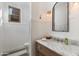 The bathroom has a marble countertop, updated fixtures, and shiplap and is move-in ready at 22406 N 36Th Way, Phoenix, AZ 85050