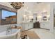 Bright bathroom with a soaking tub, double vanities, and neutral finishes at 22406 N 36Th Way, Phoenix, AZ 85050