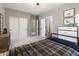 Bedroom with a plaid bedspread, gray walls, modern light fixture, and ensuite bath access at 22406 N 36Th Way, Phoenix, AZ 85050