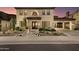 Elegant two-story home boasts desert landscaping, a porte-cochère, and a warm, inviting facade at 22406 N 36Th Way, Phoenix, AZ 85050