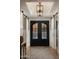 Elegant foyer featuring double doors, wood floors, and stylish lighting at 22406 N 36Th Way, Phoenix, AZ 85050