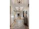 Bright hallway features wood floors, decorative lighting, and access to living spaces at 22406 N 36Th Way, Phoenix, AZ 85050